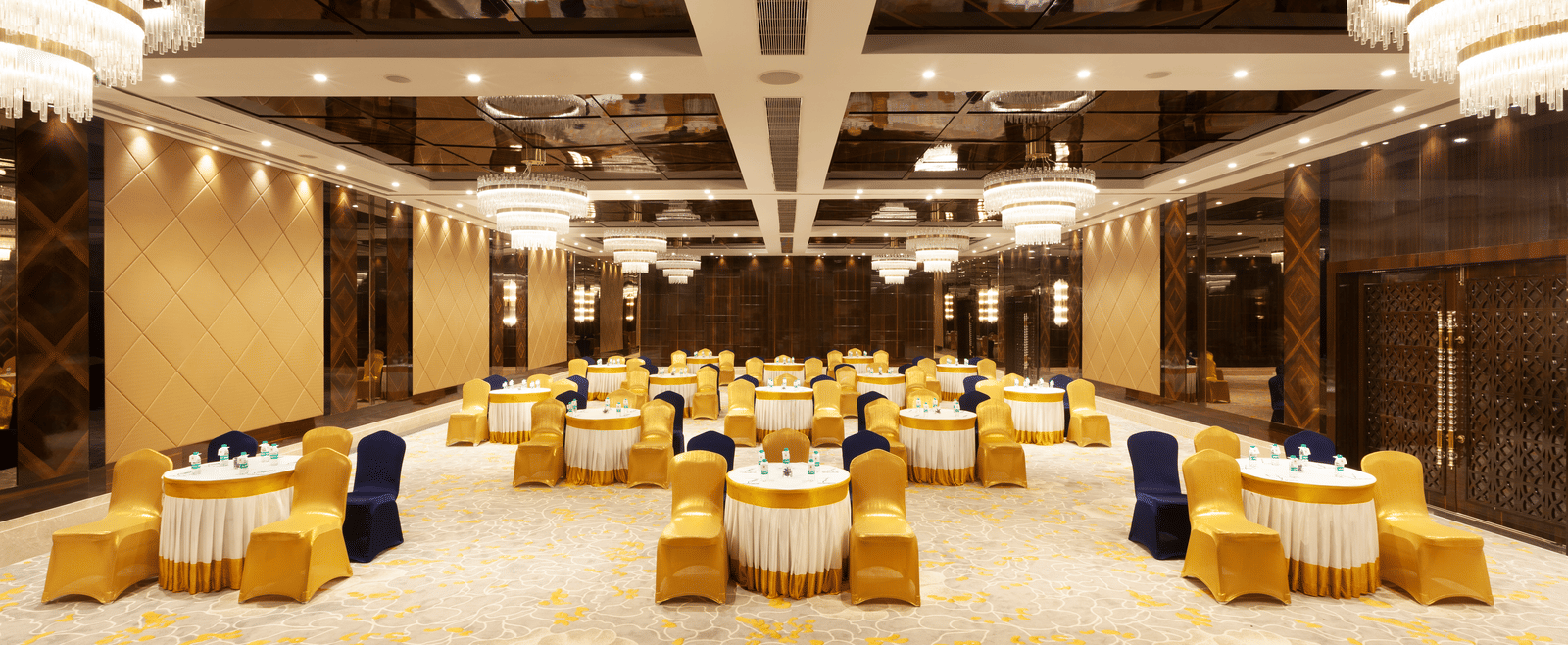 A banquet hall with round tables and chairs neatly arranged around them | Cenneys Gateway