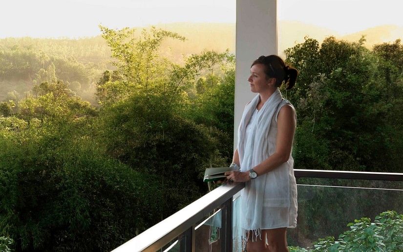 guest enjoying the view from a balcony in one of our rooms