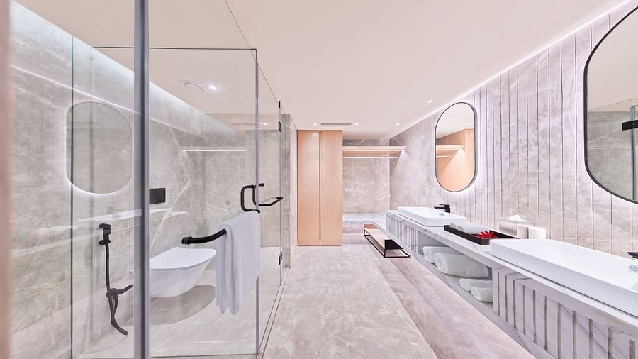 Bathroom with a mirror and glass cubicle | The Resort