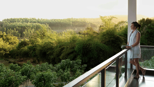guest enjoying the view from a balcony in one of our rooms