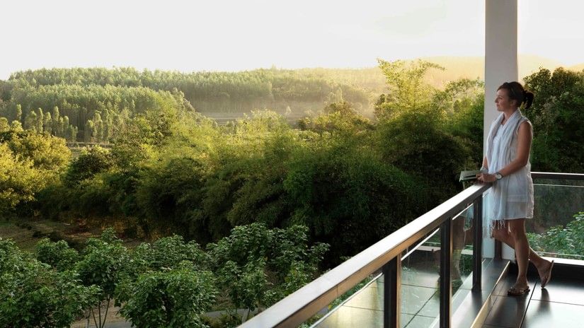 guest enjoying the view from a balcony in one of our rooms