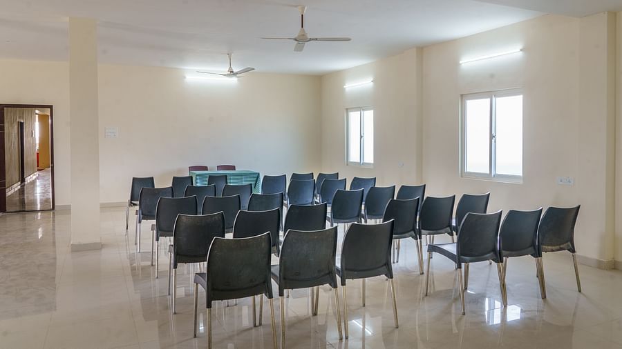 Hall with sitting chairs neatly line at Wyt Hotels, Rameswaram