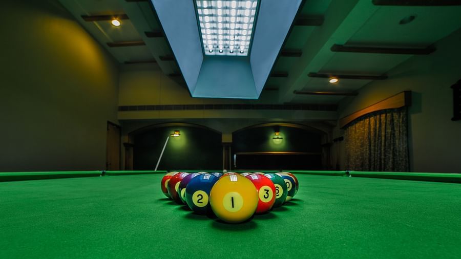 Pool table with billiards ball placed on the table at Tara, Comfort Hotel in Hyderabad - Ramoji Film City.