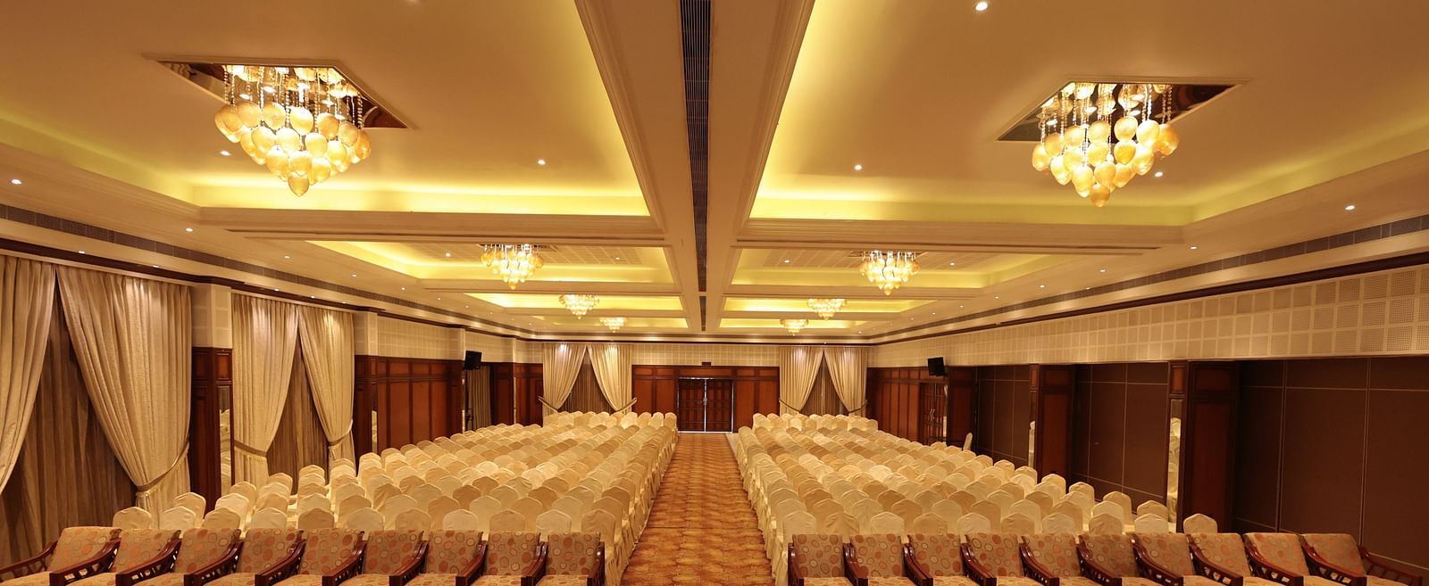 A complete view of the banquet hall with tables and chairs elegantly arranged on either side | Cenneys Gateway