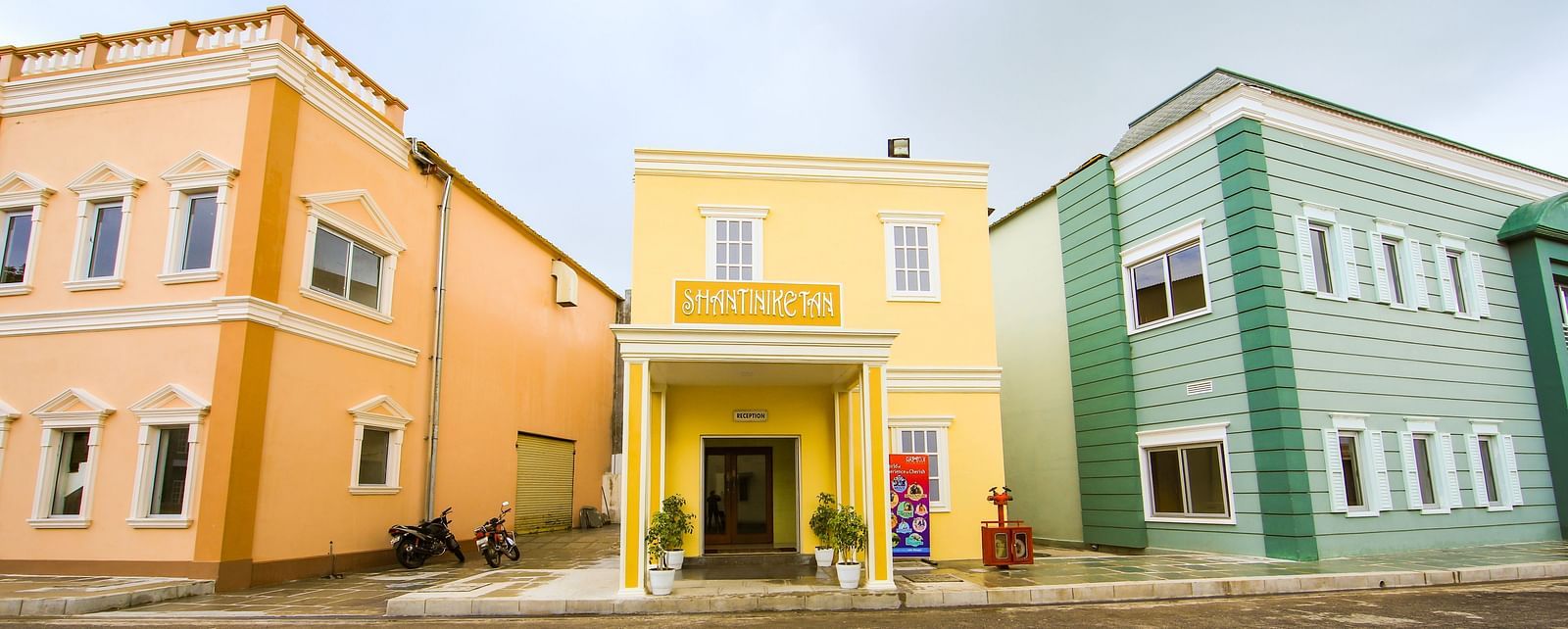 Facade of Hotel Shantiniketan in Hyderabad on a cloudy day near Ramoji Film City.