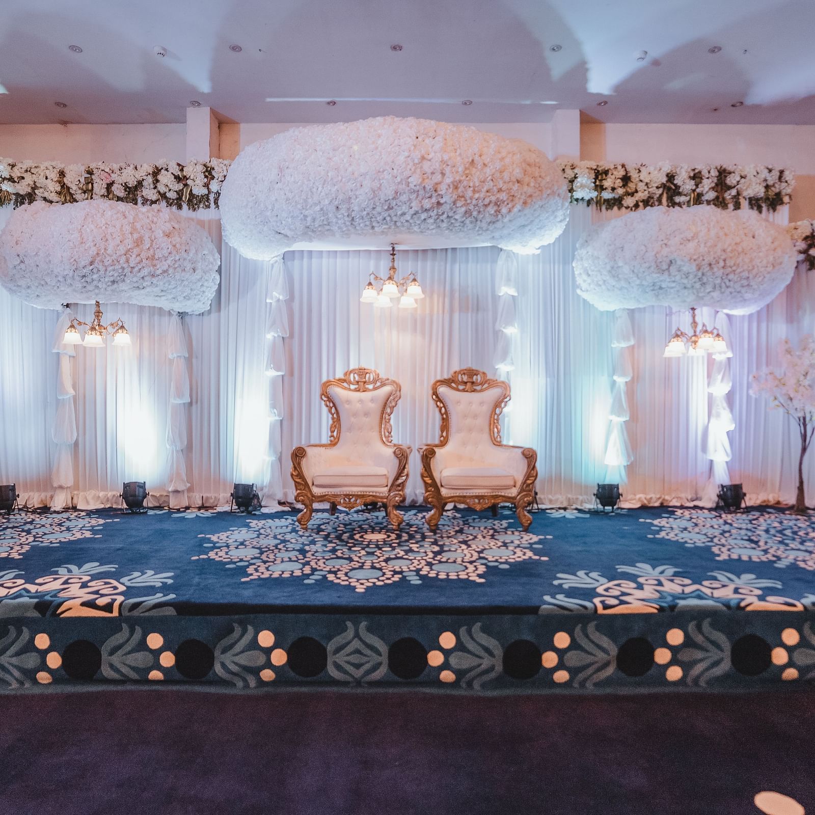 A wedding stage set up with floral arrangements at Hotel Ashok Nagpur.