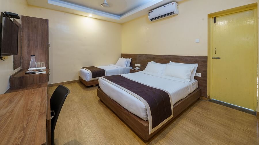 Room with two spacious bed and table at Wyt Hotels, Rameswaram 