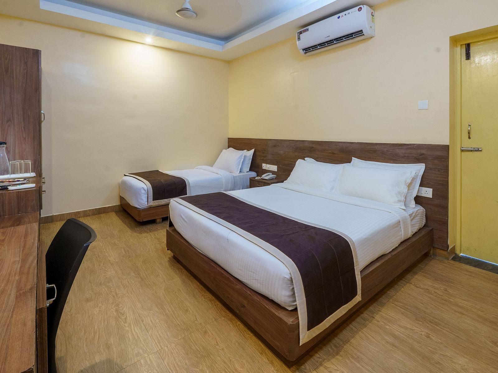 Room with two spacious bed and table at Wyt Hotels, Rameswaram 