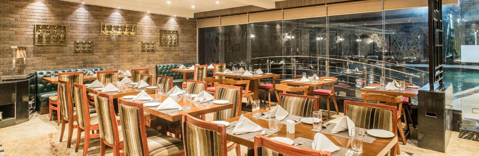Elegant hotel restaurant with neatly set tables and chairs, ready for diners | The Citi Residenci Hotel Durgapur