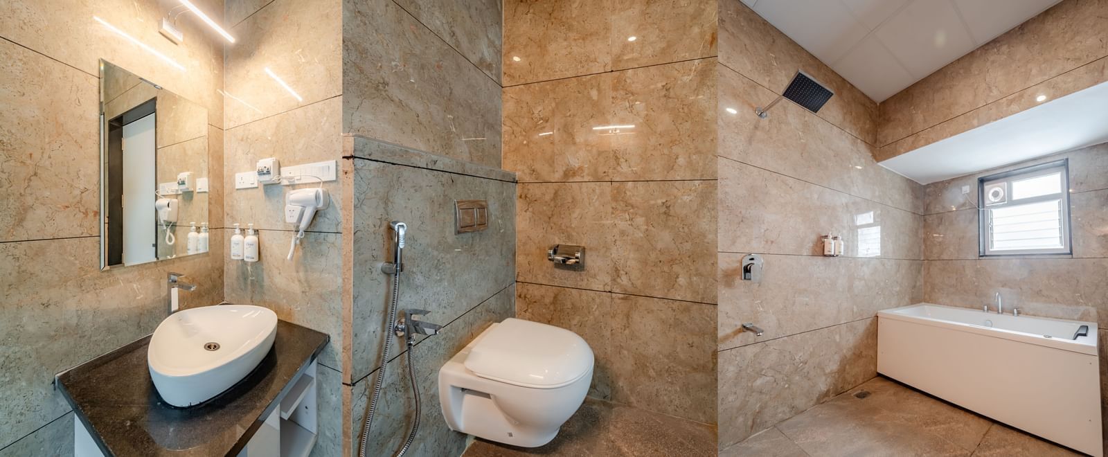 Modern bathroom with a sleek vanity, toilet, and bathtub | Suite | Pravasa Hotel, Vijayapura