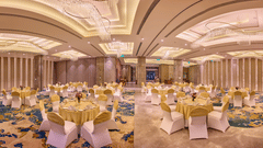 Elegant banquet hall at Riviera Sarovar Portico, Pathankot with round tables, soft lighting and spacious interiors designed for weddings and large celebrations.