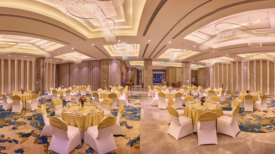 Elegant banquet hall at Riviera Sarovar Portico, Pathankot with round tables, soft lighting and spacious interiors designed for weddings and large celebrations.