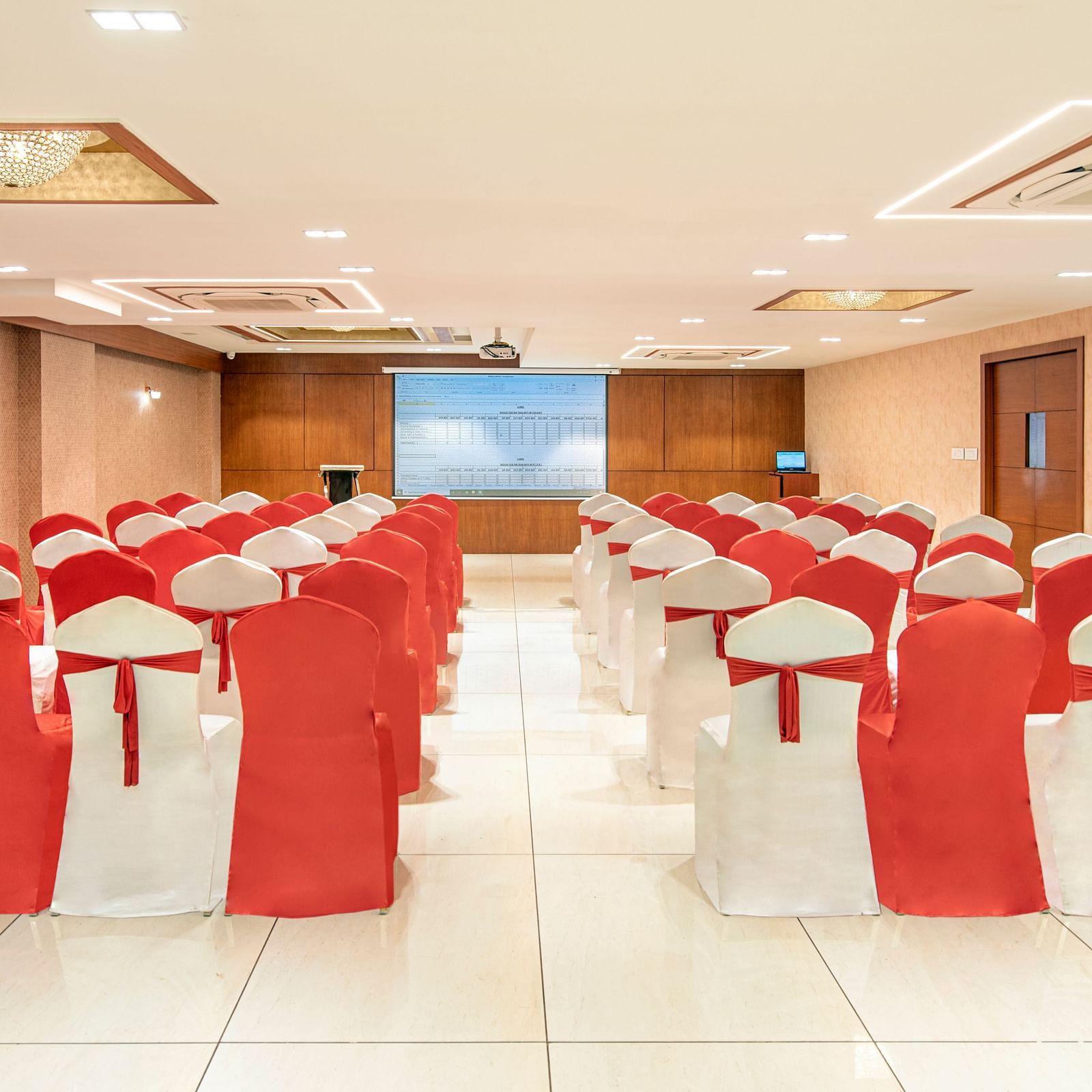 A banquet hall with tables arranged in a U-shape, possibly for a conference or meeting - SK Lords Inn Ahmedabad