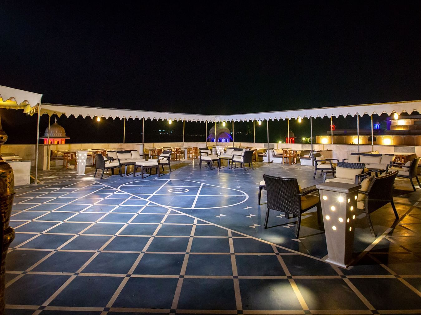 Buena Vista Luxury Garden Spa Resort - the outside seating space on the terrace at Nolita, restaurant in Jaipur at nighttime