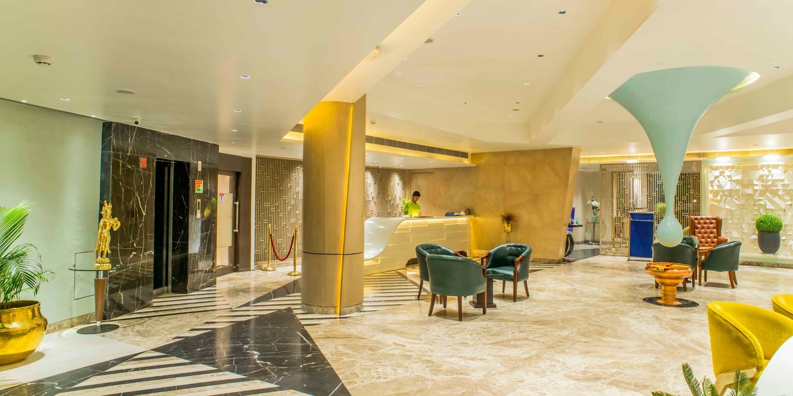Contemporary hotel lobby with comfortable armchairs, a sleek reception area, and natural light | The Citi Residenci Hotel Durgapur