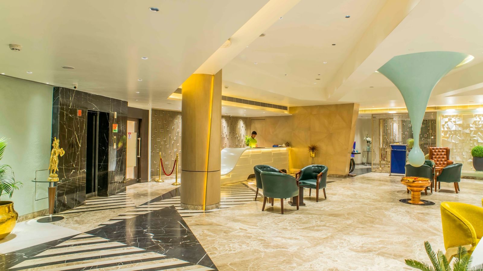 Contemporary hotel lobby with comfortable armchairs, a sleek reception area, and natural light | The Citi Residenci Hotel Durgapur