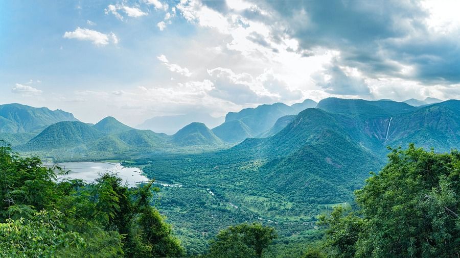 landscape vistas of lush green hills with moutains in the distance during daytime