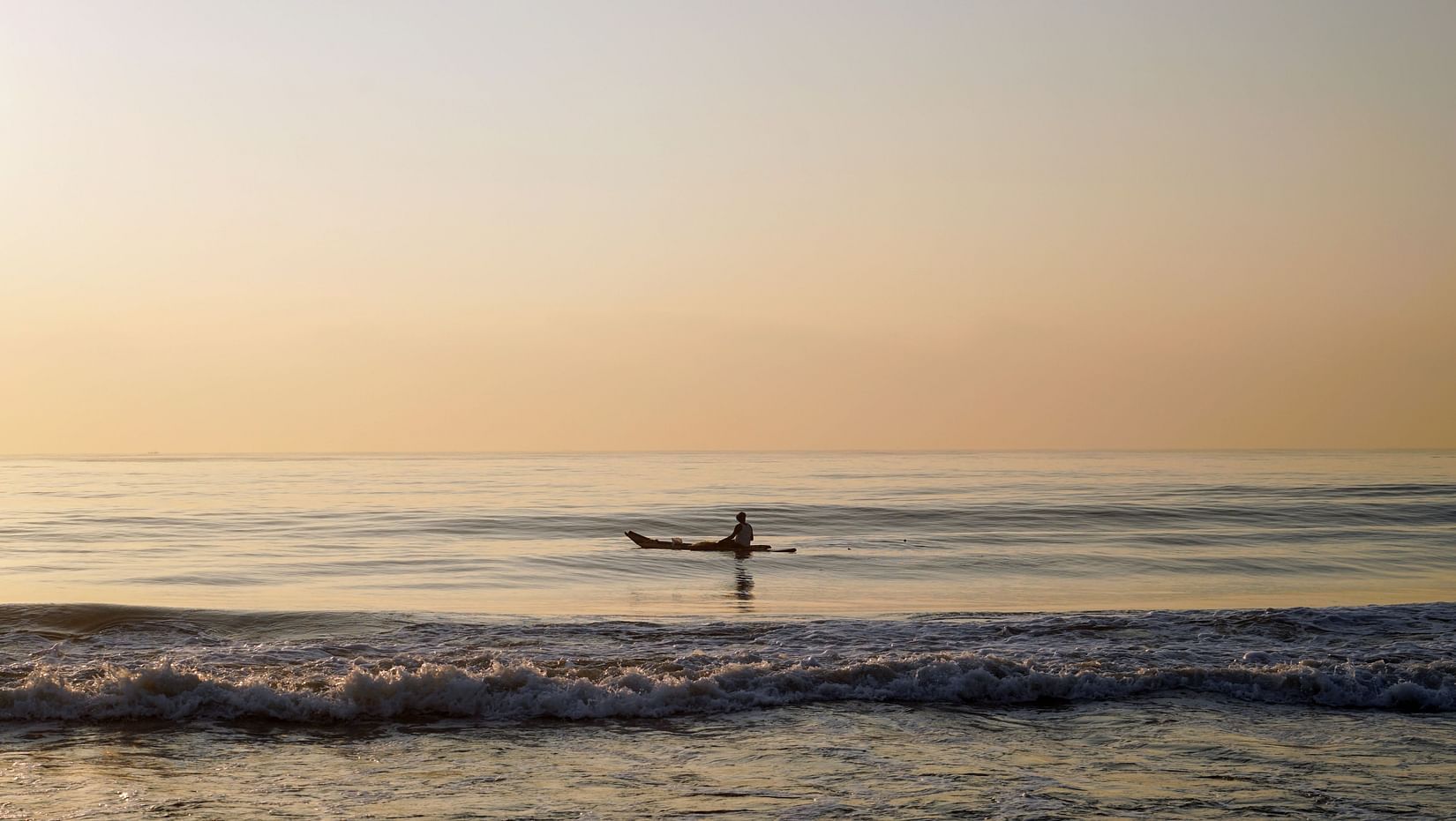 Lotus Eco beach resort, one person on a boat in the sea