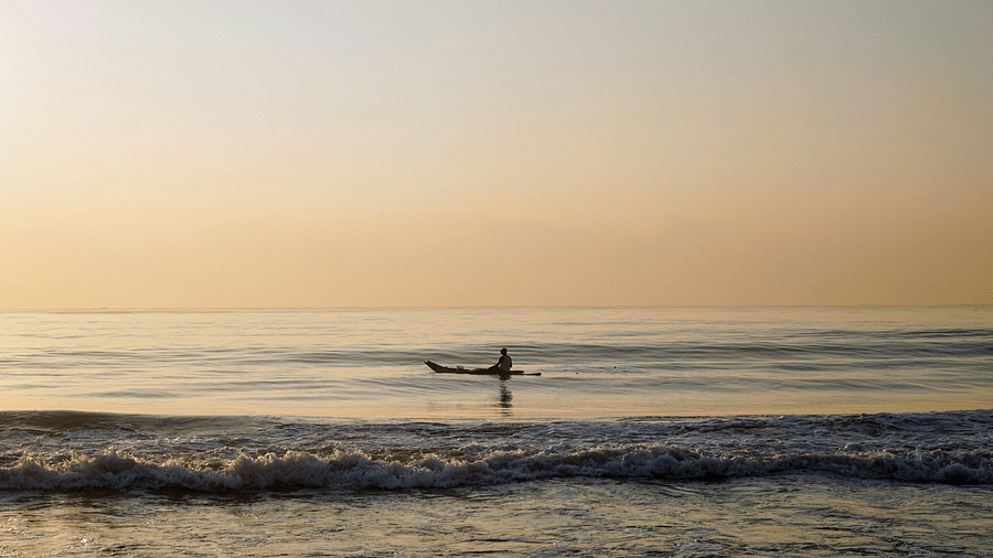 A person going on a boat in elliots beach in Chennai during the evening
