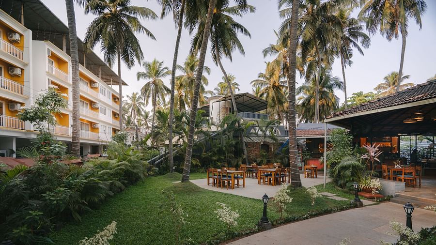 Lush green garden at Richmonde Ananta Elite, Goa with a peaceful atmosphere and outdoor seating amidst scenic surroundings.