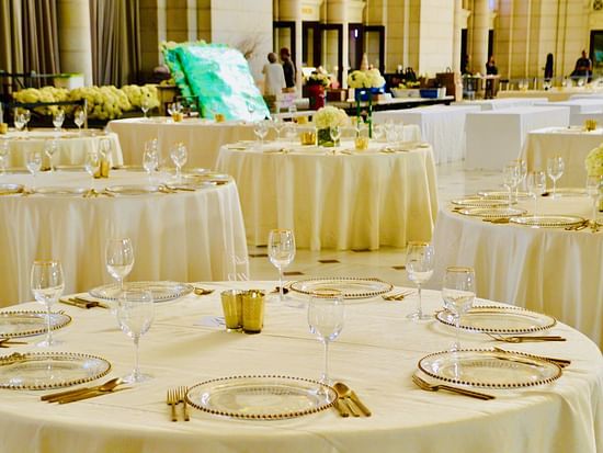 round table seating inside a room with cutlery and glasses on the table