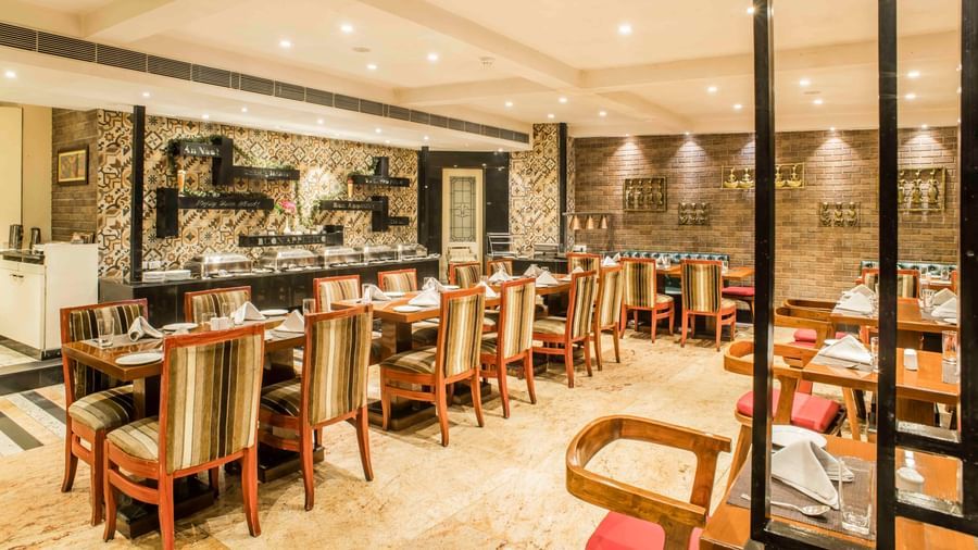Another view of the stylish hotel restaurant with a partial view of the open kitchen area| The Citi Residenci Hotel Durgapur