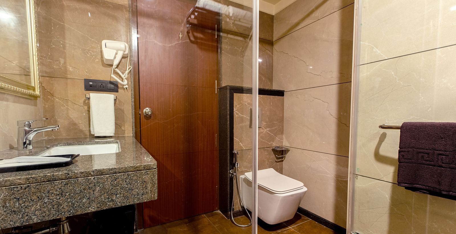 An image of a bathroom featuring a sink and a toilet at M Pro Palace.