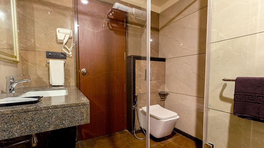An image of a bathroom featuring a sink and a toilet at M Pro Palace.