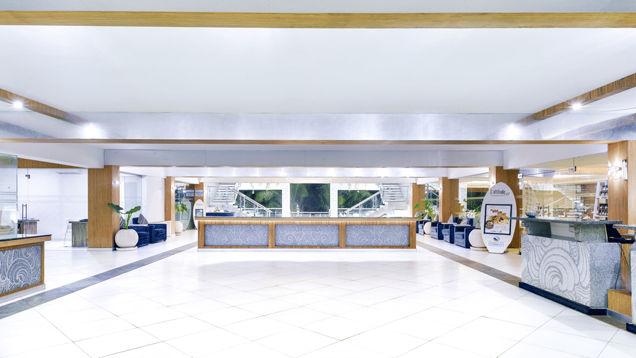 A bright, spacious lobby of our luxury beach resort on ECR featuring a long reception desk and ample seating - Grand Bay Resort & Spa - Grande Bay Resort & Spa, Mamallapuram