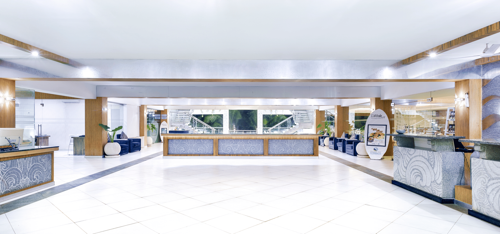 A bright, spacious lobby of our luxury beach resort on ECR featuring a long reception desk and ample seating - Grand Bay Resort & Spa - Grande Bay Resort & Spa, Mamallapuram