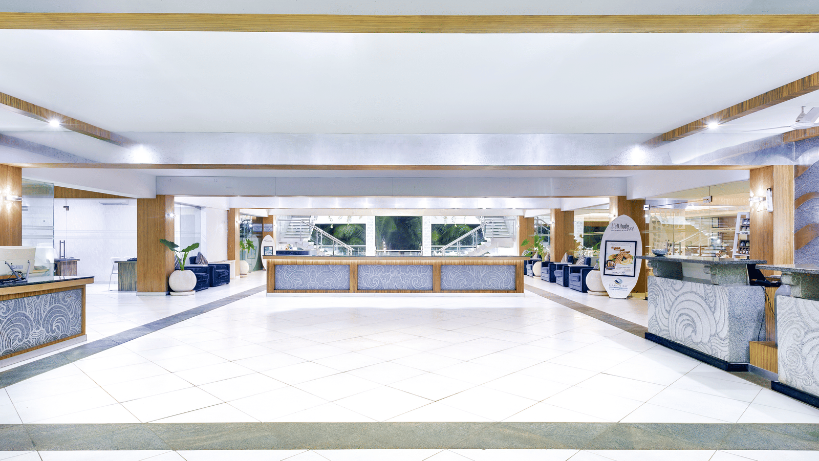 A bright, spacious lobby of our luxury beach resort on ECR featuring a long reception desk and ample seating - Grand Bay Resort & Spa - Grande Bay Resort & Spa, Mamallapuram