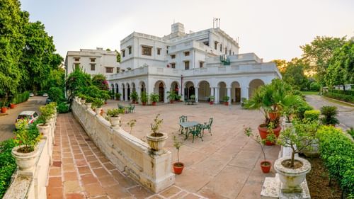 Panoramic view of the facade with metal chairs and table in the foreground - The Baradari Palace