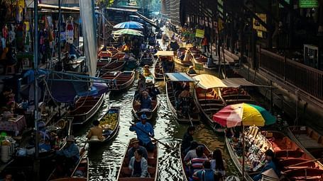 an overview of a floating market with different boats selling different things