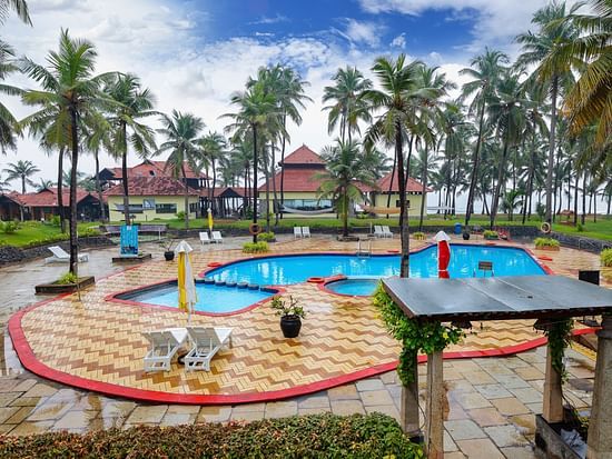 the pool surrounded by palm trees at MGM Beach Resorts, Muthukadu