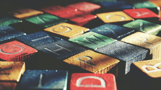 A close-up shot of several colourful wooden building blocks.