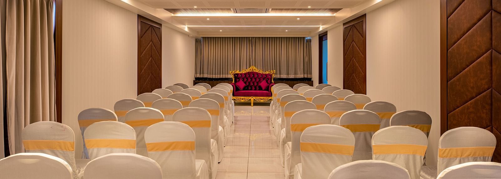 Rear view of the event hall at M Pro Palace, showcasing neatly arranged chairs.