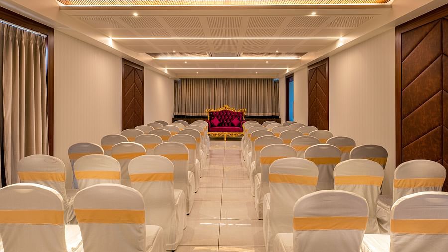 Rear view of the event hall at M Pro Palace, showcasing neatly arranged chairs.
