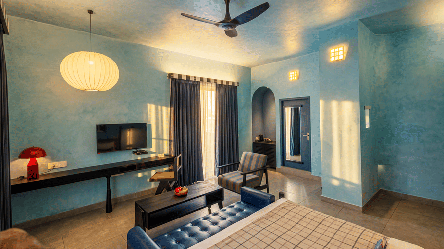A bedroom featuring a king size bed, a television mounted on the wall, a ceiling fan, a chair at The Sierra - By The Lake.
