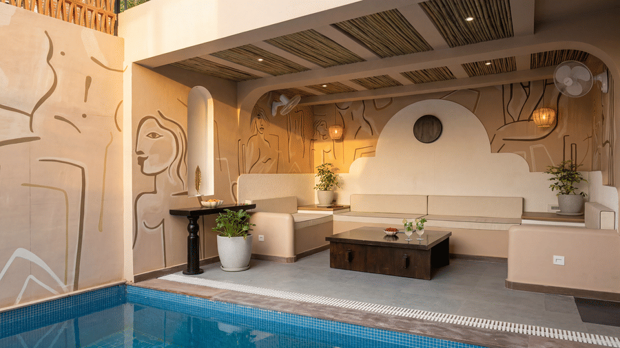 A patio at The Sierra - By The Lake featuring a private plunge pool, an outdoor lounge sofa with cushions, and a low wooden coffee table.