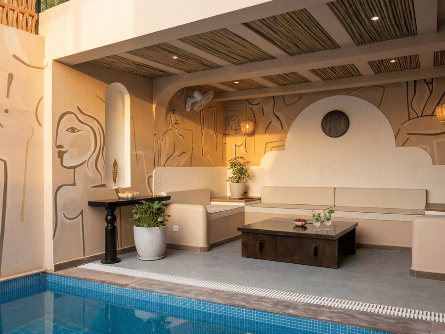 A patio at The Sierra - By The Lake featuring a private plunge pool, an outdoor lounge sofa with cushions, and a low wooden coffee table.