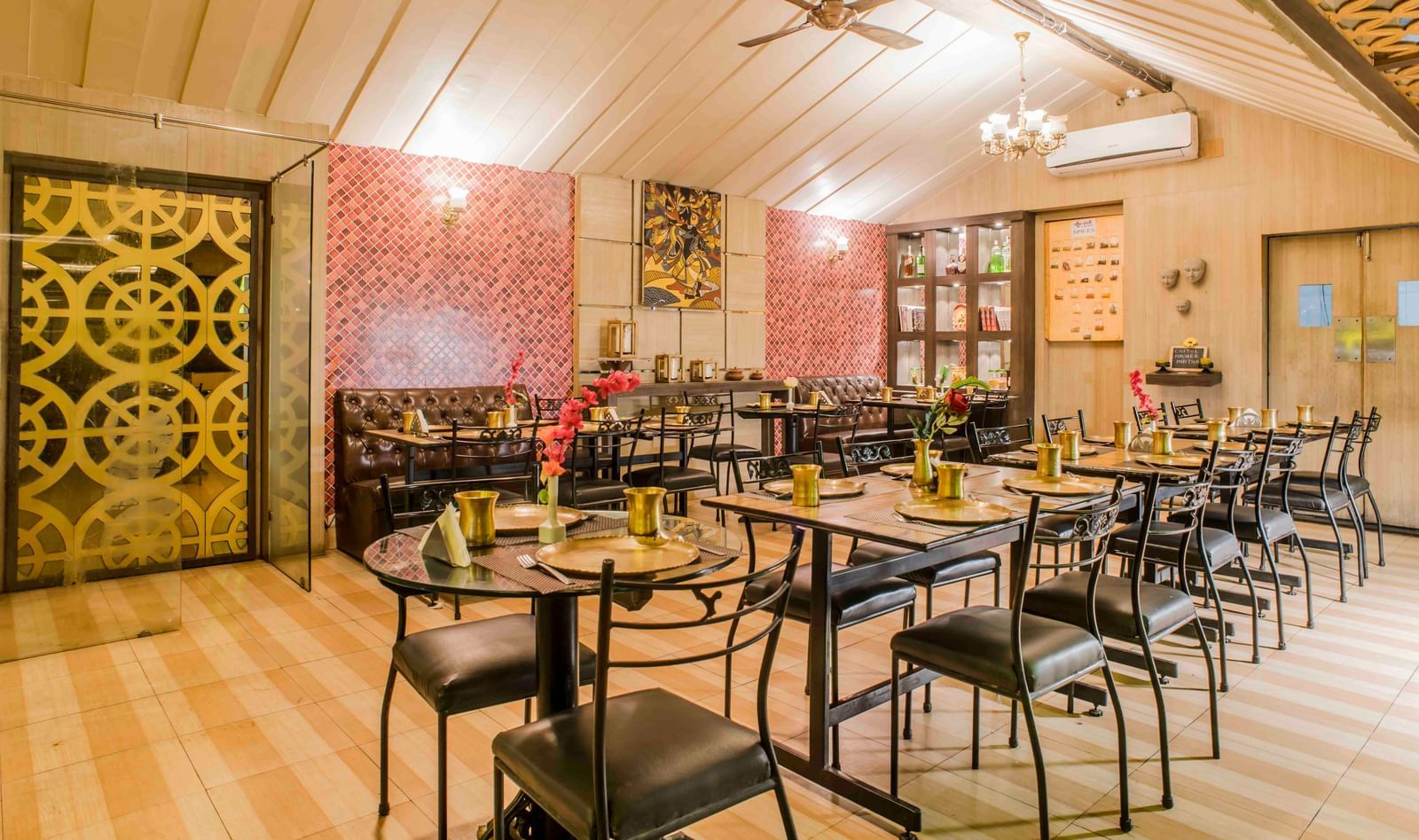A restaurant dining area with tables and chairs at The Citi Residenci Hotel, Durgapur.