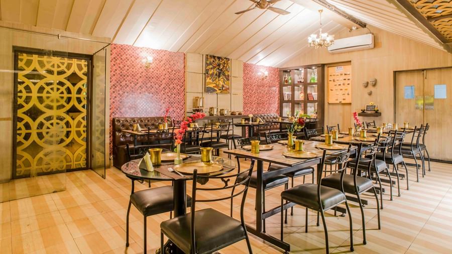 A restaurant dining area with tables and chairs at The Citi Residenci Hotel, Durgapur.