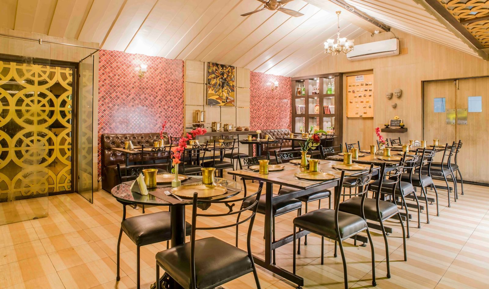 A restaurant dining area with tables and chairs at The Citi Residenci Hotel, Durgapur.
