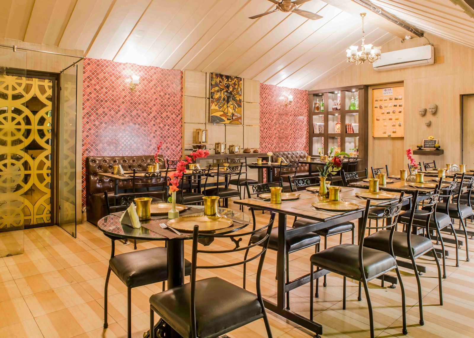 A restaurant dining area with tables and chairs at The Citi Residenci Hotel, Durgapur.