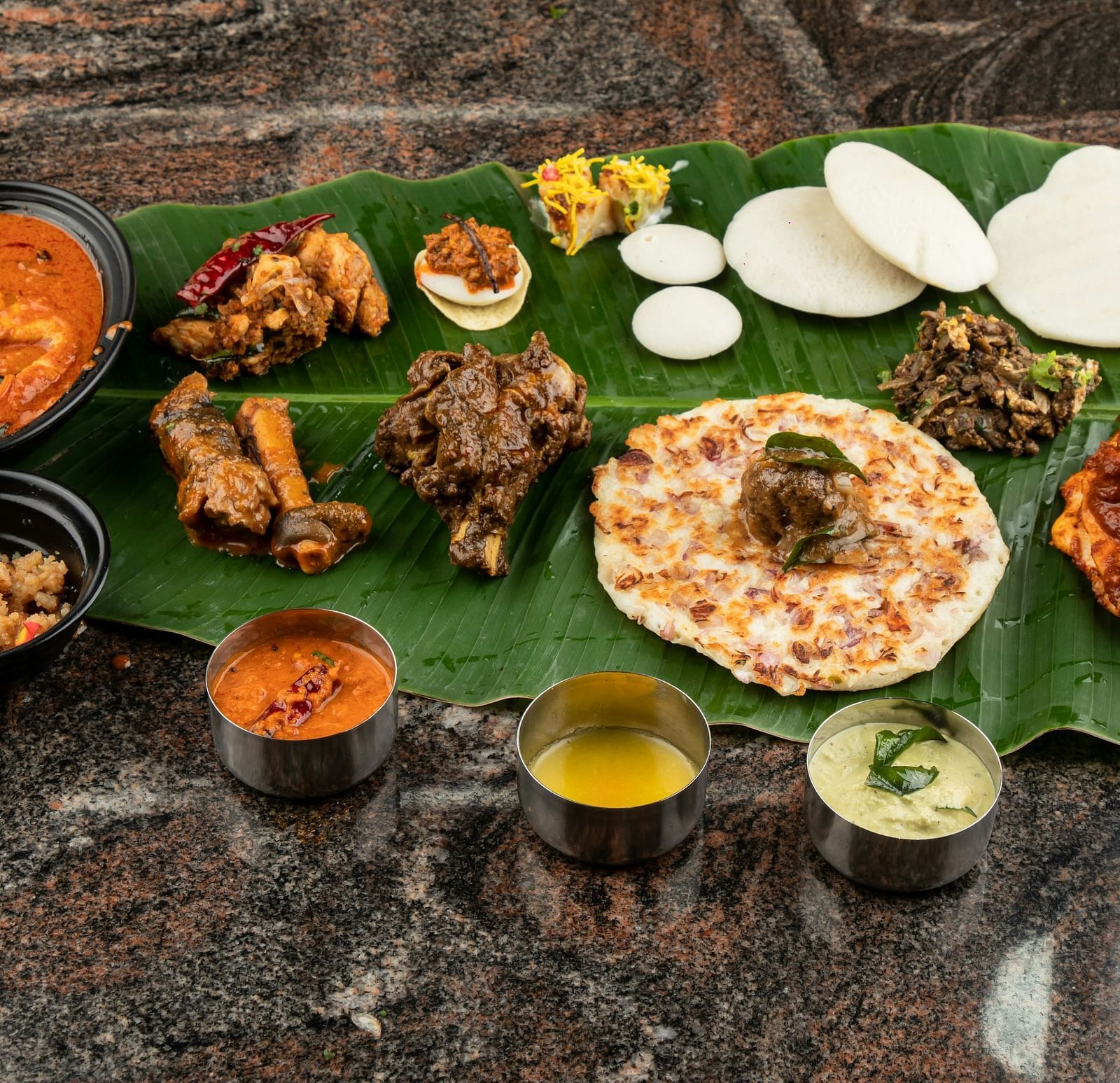 A traditional South Indian thali meal with various dishes served on a banana leaf