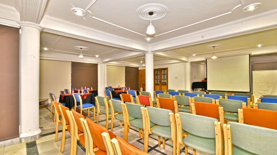 Back view of the event space with chairs arranged and a patterned ceiling at DLS Hillcrest Resort, Shimla.