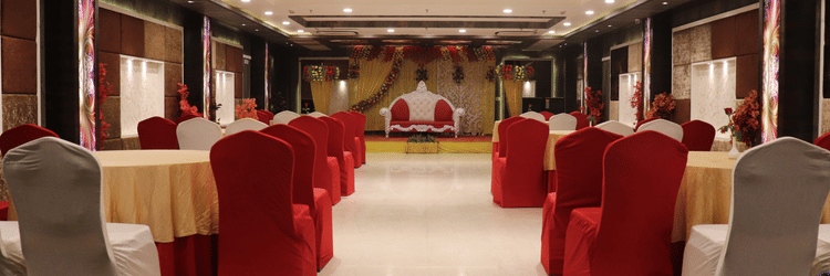 Tables and chairs are arranged on both sides, with a pathway in the middle leading to the stage.