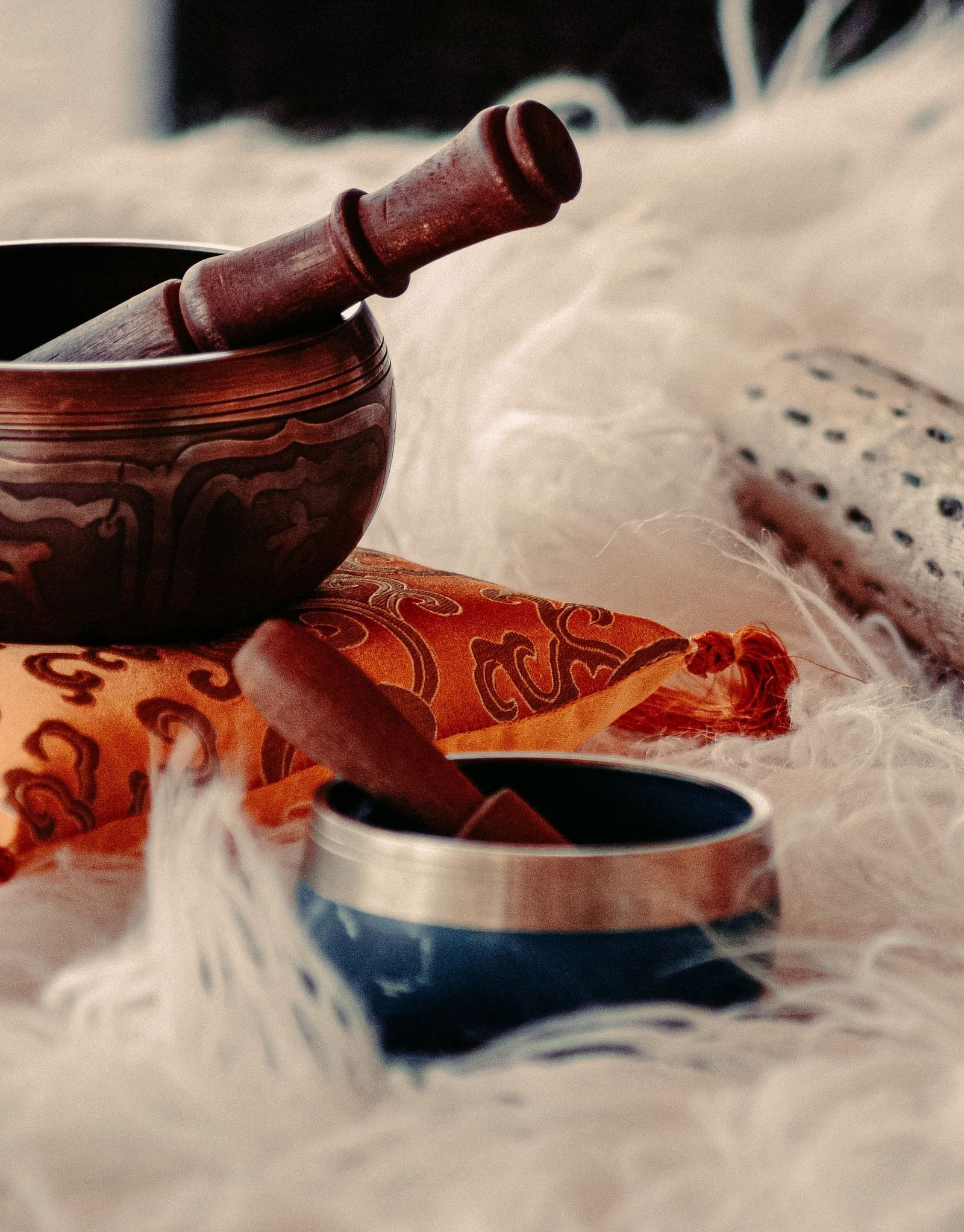 instruments used for sound therapy placed on a white fur cloth