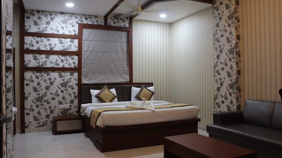 A stylish hotel room interior with contemporary design and warm lighting showcasing premium accommodations available through Varanasi hotel deals - Hotel Uday Palace.