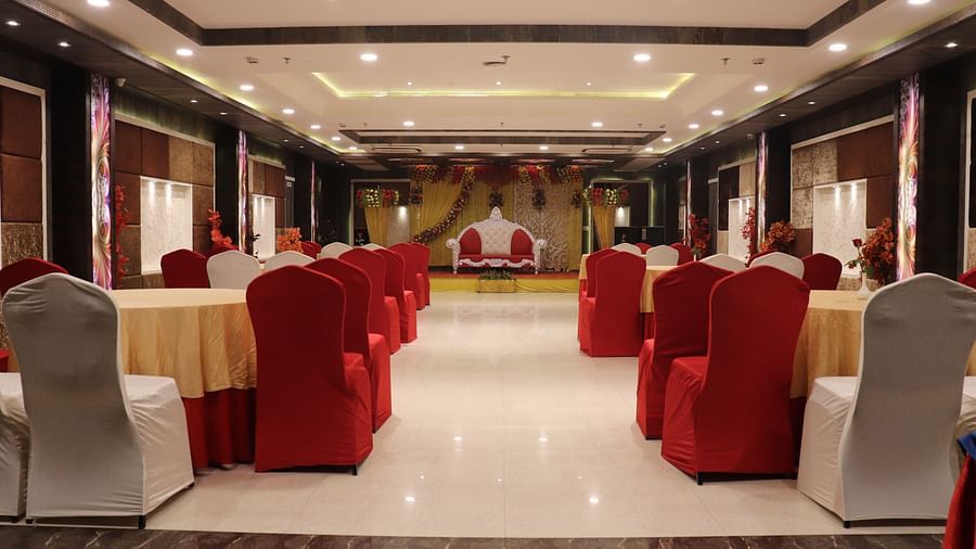 Tables and chairs are arranged on both sides, with a pathway in the middle leading to the stage.